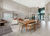 Thumbnail 23 of 33 - A modern dining room with a wooden table and chairs.