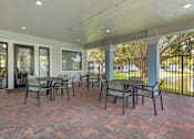 Thumbnail 19 of 33 - A patio with a table and chairs.