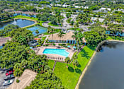 Thumbnail 31 of 33 - A bird's eye view of a resort with a swimming pool and a lake.