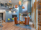 Thumbnail 30 of 37 - A living room with a brown leather chair at Glenwood at Grant Park, Atlanta, Georgia