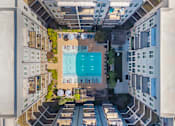 Thumbnail 22 of 37 - A swimming pool is surrounded by apartment buildings at Glenwood at Grant Park, Atlanta, GA