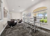 Thumbnail 37 of 38 - A conference room with a table and chairs.