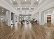 Thumbnail 31 of 38 - A spacious room with wooden floors and a high ceiling.