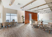 Thumbnail 22 of 26 - A room with wooden floors and furniture.