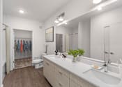 Thumbnail 6 of 42 - A bathroom with a white counter top and a white sink.
