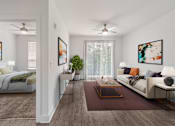 Thumbnail 1 of 42 - A modern living room with a white sofa, a coffee table, and a bed with a green blanket.