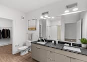 Thumbnail 3 of 42 - A bathroom with a toilet, sink, and mirror.