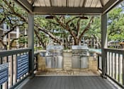 Thumbnail 26 of 38 - A covered outdoor area with a grill and a sign that says "Grill on Light the Grill".