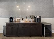 Thumbnail 30 of 38 - A kitchen island with a coffee maker, toaster, and other items on it.