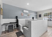 Thumbnail 31 of 38 - A modern kitchen with a white tiled backsplash and a black countertop.