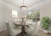 Thumbnail 3 of 38 - A dining room with a round table and chairs.
