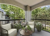 Thumbnail 5 of 38 - A patio with a table and chairs overlooking a street.