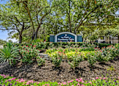 Thumbnail 38 of 38 - A sign for The Park at Montego Oaks is surrounded by a garden.