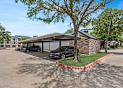 Thumbnail 20 of 38 - A black car is parked in a driveway.