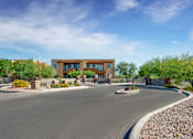 Thumbnail 25 of 29 - A modern building with a curved driveway in front.