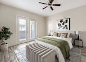 Thumbnail 2 of 29 - A bedroom with a bed, pillows, a ceiling fan, and a plant.