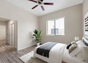 Thumbnail 8 of 29 - A bedroom with a bed, a ceiling fan, and a plant.