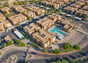 Thumbnail 27 of 29 - A bird's eye view of a residential area with a roundabout and a swimming pool.