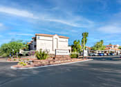 Thumbnail 31 of 37 - The Promontory sign is on a building with a parking lot in front.