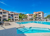 Thumbnail 17 of 37 - A swimming pool in front of apartment buildings.