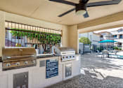 Thumbnail 18 of 37 - A patio with a grill and a fan.