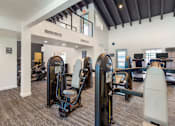 Thumbnail 19 of 37 - A gym with a row of treadmills and elliptical machines.