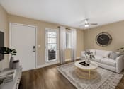 Thumbnail 4 of 37 - A living room with a white couch, a coffee table, and a ceiling fan.