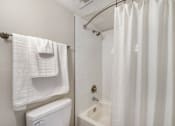 Thumbnail 8 of 37 - A white towel hangs on a towel rack in a bathroom.