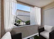 Thumbnail 6 of 37 - A balcony with a chair and a table with a plant on it.