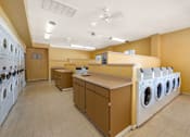 Thumbnail 28 of 37 - A laundromat with washers and dryers.