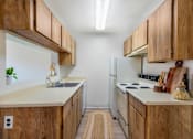 Thumbnail 11 of 37 - A kitchen with wooden cabinets and a white refrigerator.
