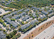 Thumbnail 36 of 36 - A bird's eye view of a residential area with houses and a highway.