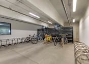 Thumbnail 26 of 27 - A bike parking area with bicycles parked in metal racks.
