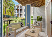 Thumbnail 7 of 27 - Wooden patio set with a couch at Thornberry Apartments, Charlotte, North Carolina