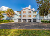 Thumbnail 10 of 28 - Exterior view of the apartment buildings showcasing the built-in garages available