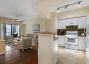 Thumbnail 1 of 28 - A modern kitchen with an open concept layout that opens up into the living room