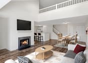 Thumbnail 3 of 26 - A modern living room with a fireplace and a television at Residences at Westborough Station, Westborough, MA