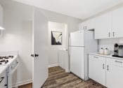Thumbnail 4 of 26 - A kitchen with white appliances and cabinets at Residences at Westborough Station, Westborough, MA