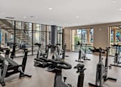 Thumbnail 26 of 39 - A gym with a row of stationary bikes.