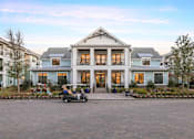 Thumbnail 24 of 33 - A large house with a driveway in front of it.