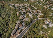 Thumbnail 7 of 27 - Road with houses on both sides at Great Hills, Austin Texas