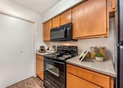 Thumbnail 25 of 27 - Kitchen with a black microwave above the stove at Great Hills, Austin, 78759  