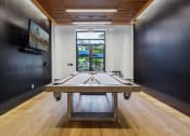 Thumbnail 12 of 34 - a game room with a ping pong table and a window at The Merc, Waltham, Massachusetts