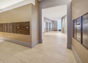 Thumbnail 25 of 34 - a view of a hallway with mailboxes in a lobby at The Merc, Waltham, MA, 02453