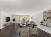 Thumbnail 36 of 40 - a living room and dining room with a black table and chairs at Residences at Westborough Station, Westborough, MA, 01581