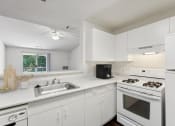 Thumbnail 39 of 40 - a kitchen with white cabinets and appliances and a sink at Residences at Westborough Station, Westborough, 01581