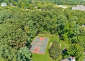 Thumbnail 19 of 40 - a aerial view of a basketball court in the middle of a park at Residences at Westborough Station, Westborough, Massachusetts