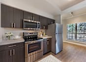 Thumbnail 4 of 31 - Large Island Kitchen With Custom Cabinetry at Sedona Springs, Texas
