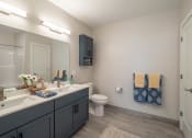 Thumbnail 9 of 33 - a bathroom with a toilet, a sink and a mirror at Edgebrook Residences, Merrimack, NH