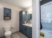 Thumbnail 11 of 33 - a bathroom with a full size washer and dryer at Edgebrook Residences, Merrimack, 03054